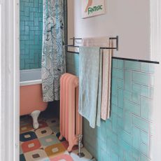 Blue and pink bathroom with towel storage on wall