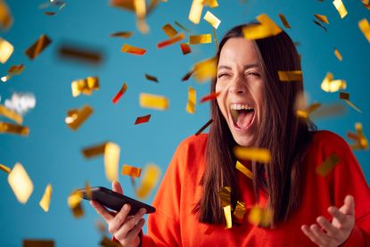 Woman celebrates after winning Premium Bonds prize