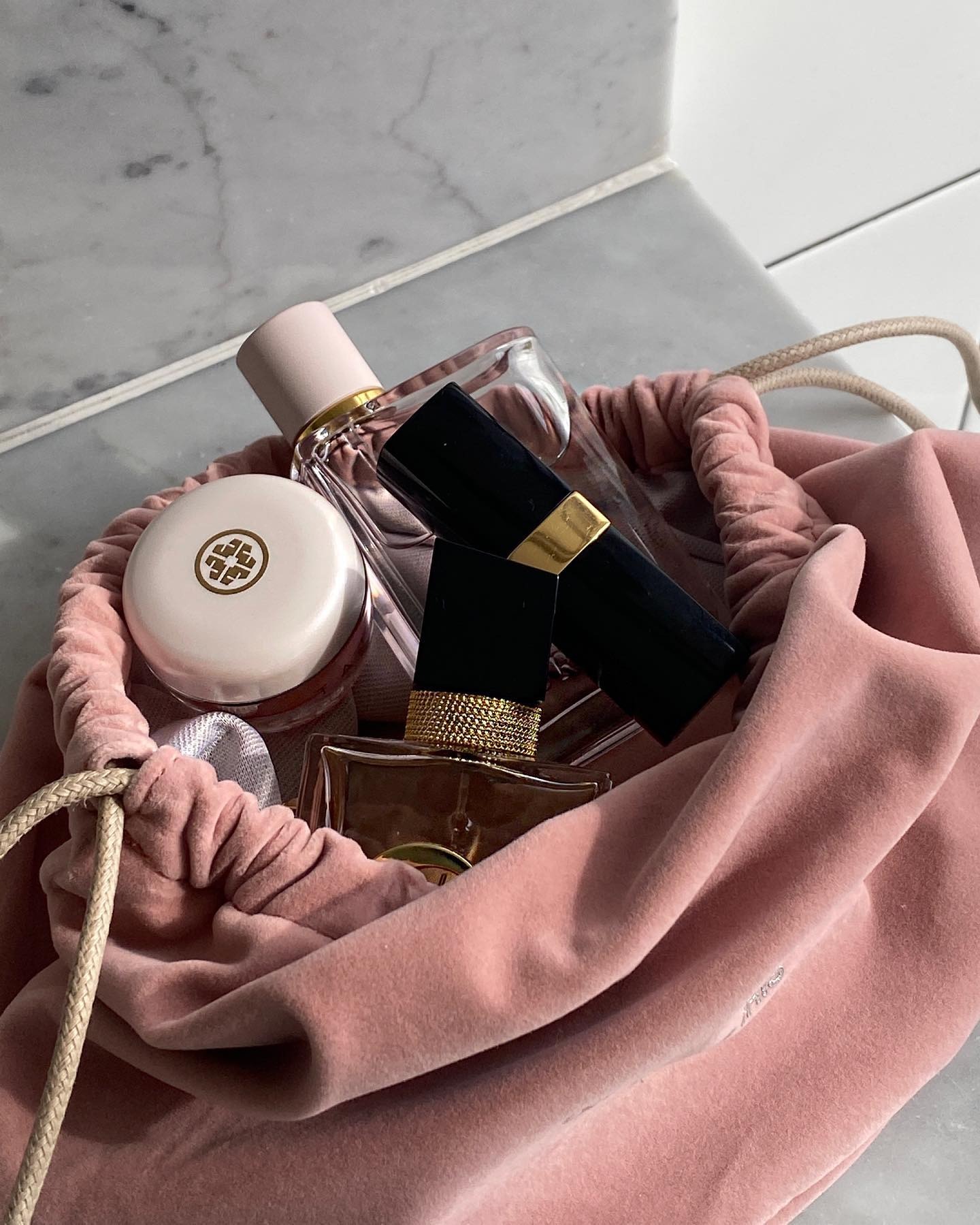 A picture of a Burberry perfume in a velvet pink pouch