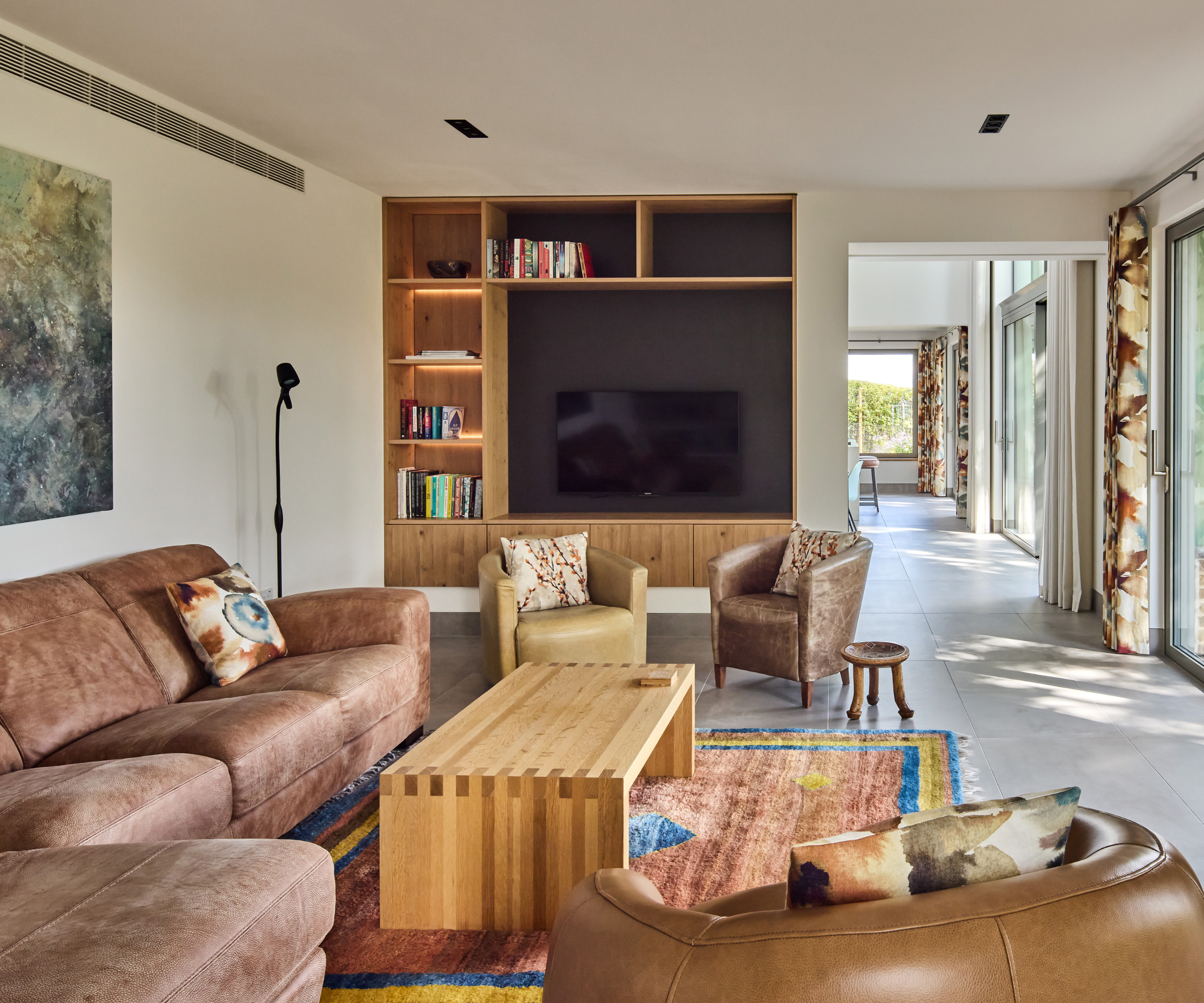 Living room with media wall and brown furnishings 