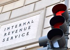 image of IRS sign with red traffic light in the foreground
