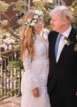 Prime Minister Boris Johnson poses with his wife Carrie Johnson in the garden of 10 Downing Street following their wedding at Westminster Cathedral, May 29, 2021 in London, England