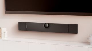the devialet dione dolby atmos soundbar mounted below a tv