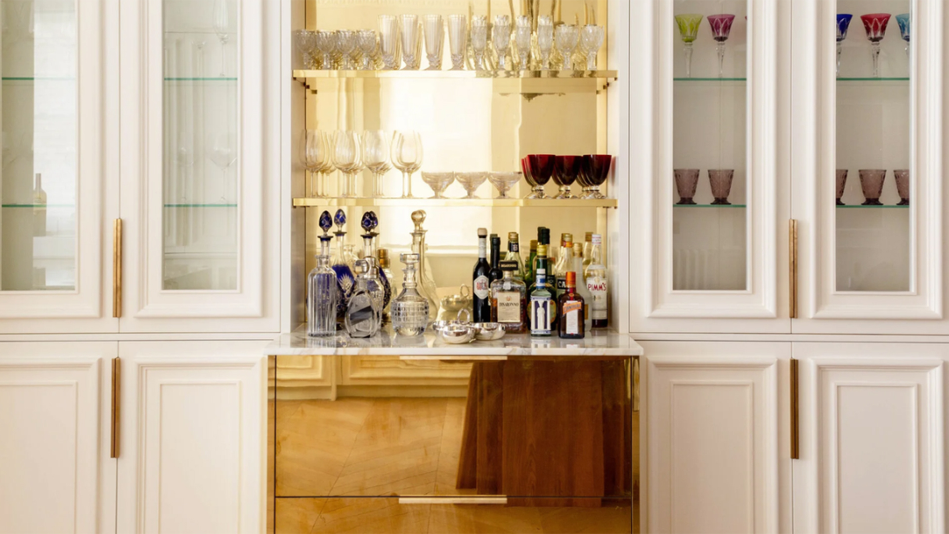Luxe home bar with mirror gold shelving
