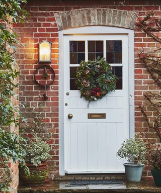 Festive front door with foliage Christmas wreath