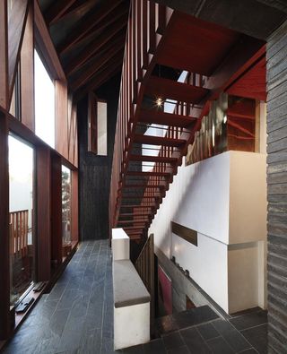 The darker timber backdrop, natural stone floors and shuttered internal windows provide a rustic barnlike aesthetic rooting the building to its past