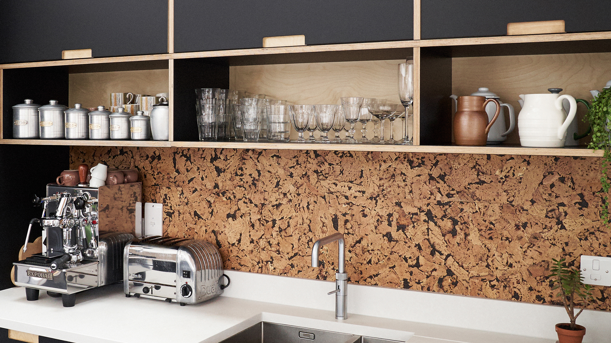 cork splashback in modern black kitchen