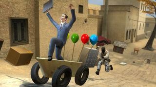 Garry&#039;s Mod screen - G-Man riding a balloon-festooned cart with his hands held above his head while a Counter-Strike guy chases him