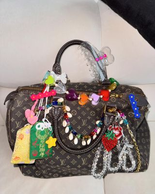 Louis Vuitton bag covered in Bonbonwhims charms.