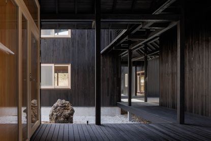 Shishi-iwa House by Ryue Nishizawa, dark wood sheltered terraces outside