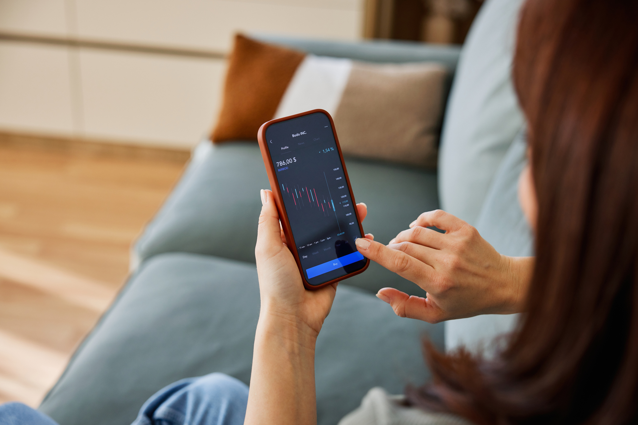 woman at home uses a smartphone trading app to monitor stocks funds and investment trusts