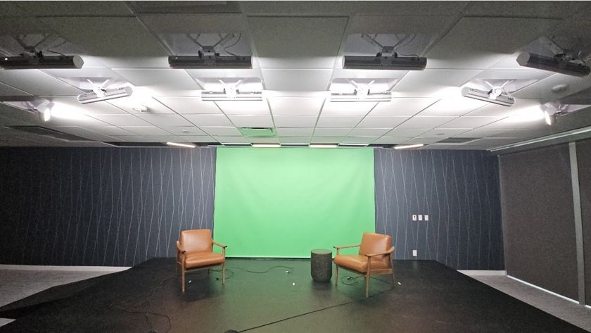 The new podcast studio lit up at Associa.