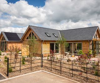 A single storey timber frame home built on a plot alongside other oak frame homes