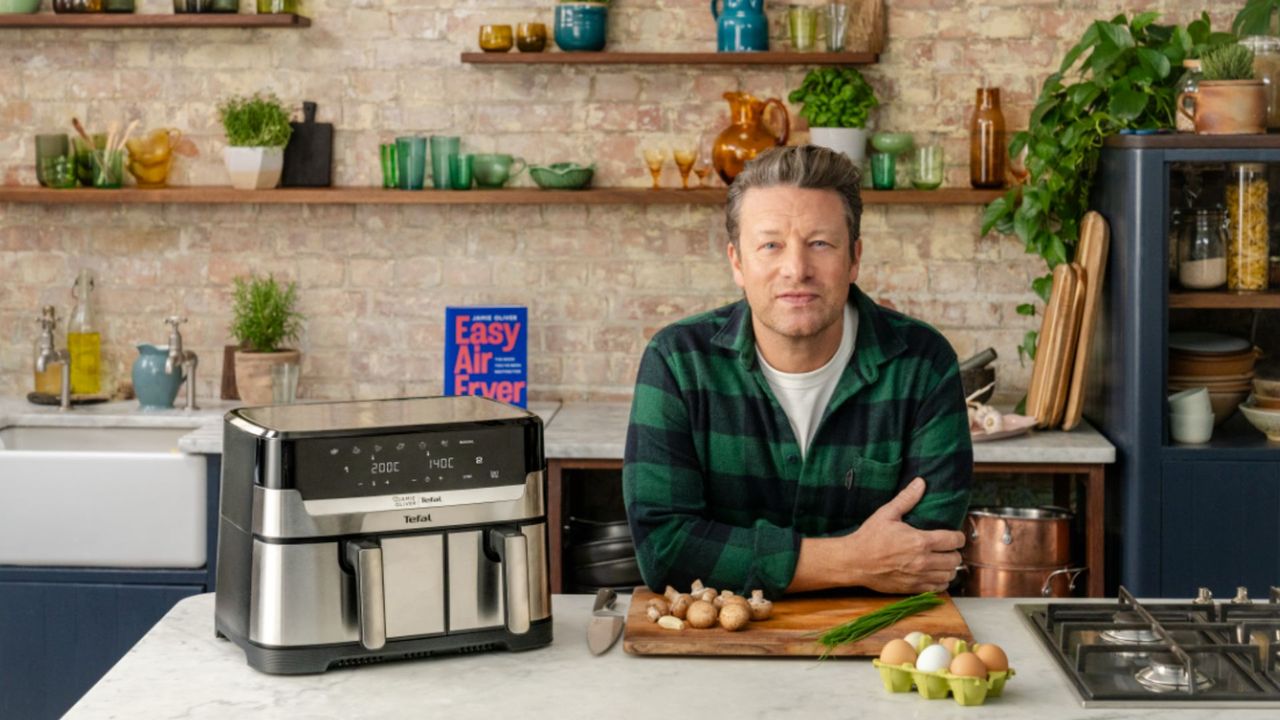 Jamie&#039;s Air Fryer meals: Jamie Oliver beside the Jamie Oliver by Tefal Air Fryer with his new air fryer book in the background