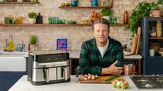 Jamie's Air Fryer meals: Jamie Oliver beside the Jamie Oliver by Tefal Air Fryer with his new air fryer book in the background