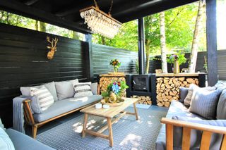 covered outdoor living room with an outdoor firep