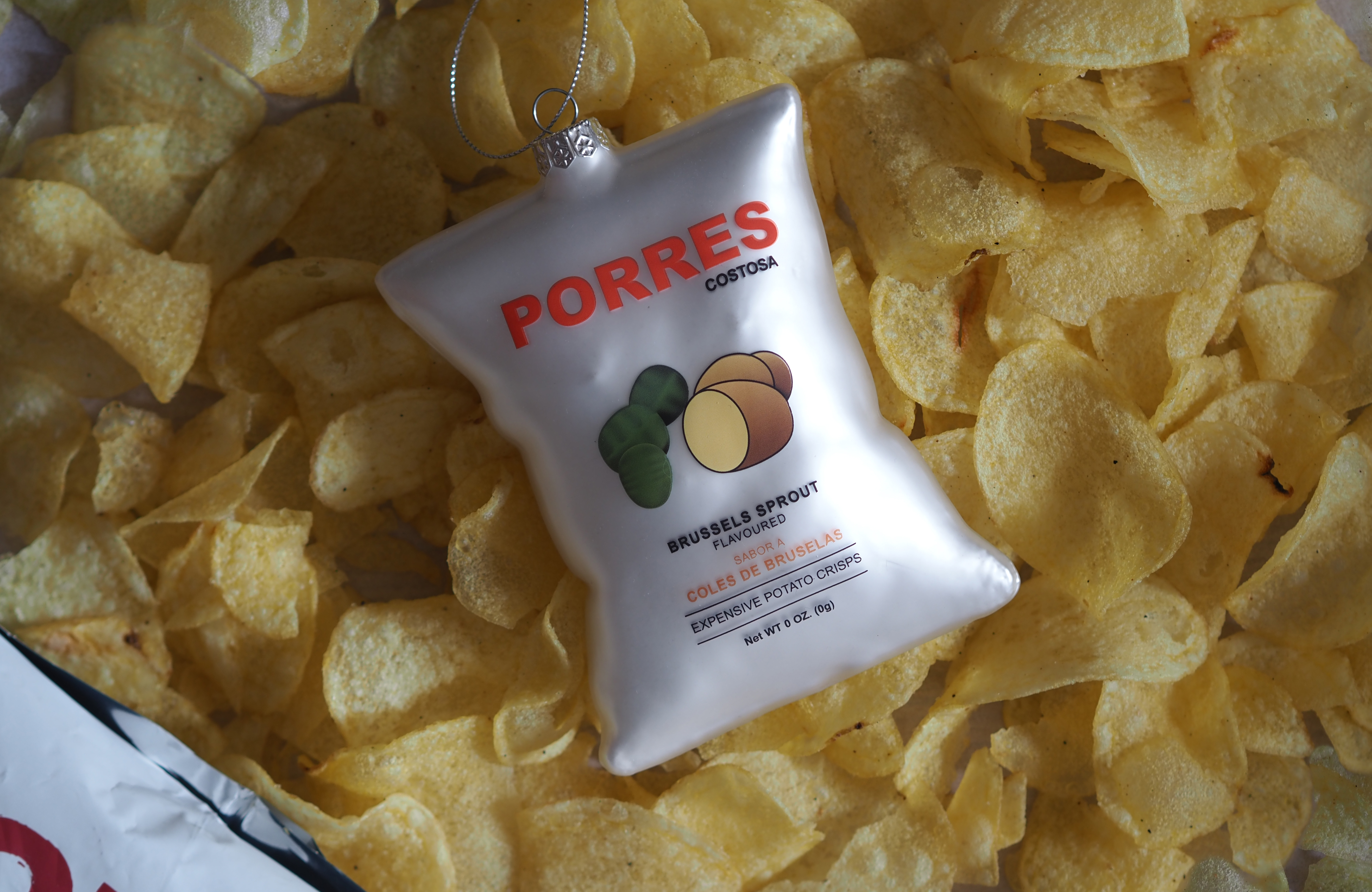 a torres crisp inspired christmas decoration on a pile of crisps