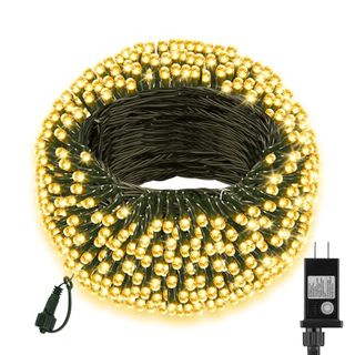 A coil of warm white Christmas lights with a green string and a two-pin plug. 