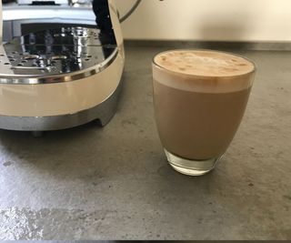 A latte made un the Smeg ECF02
