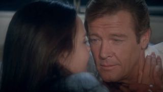 Roger Moore embracing with Carole Bouquet in For Your Eyes Only.