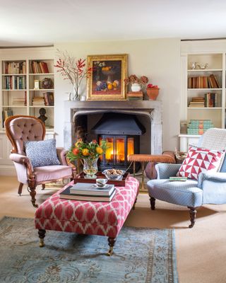 Living room with armchairs and footstool and wood stove