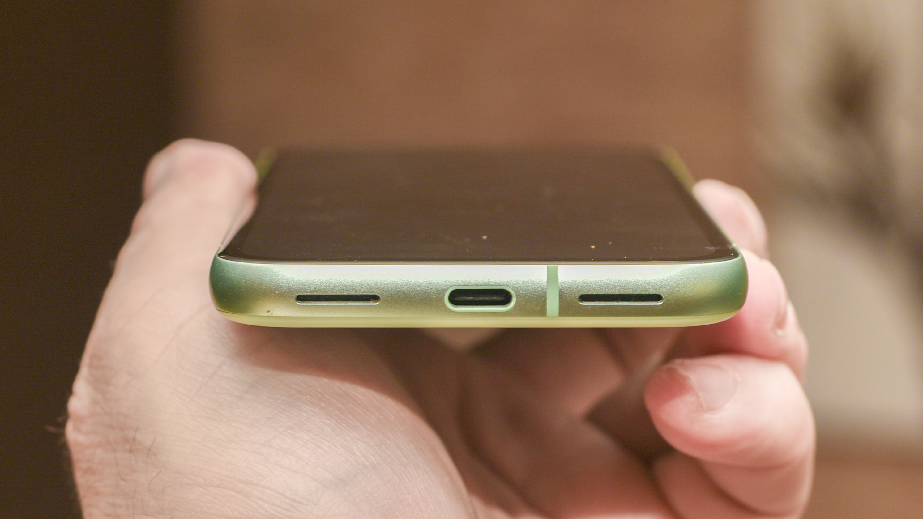 Google Pixel 8a in aloe green showing USB-C charging port