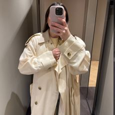 Woman wears cream jacket