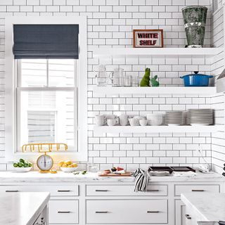 kitchen with white kitchen tiles and cabinet