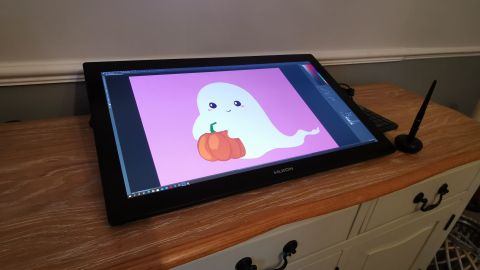 The Huion Kamvas 24 Pro 4K on a sideboard displaying a spooky Halloween ghost