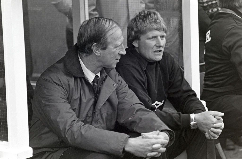 Newcastle United manager Jack Charlton (l) and coach Willie (Iam) McFaul look on from the bench before a match against Luton Town at St James&#039; Park on February 23rd, 1985 in Newcastle upon Tyne, England.