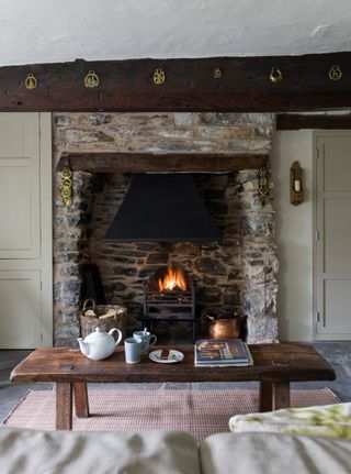 stone fireplace in living room with tray