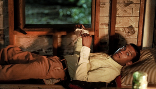 Joshua Boone as Bayou, lying down