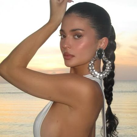 Kylie Jenner wore a little white tank top dress with deep side cut-outs on vacation