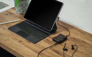 Chord Mojo 2 connected to earbuds and a laptop