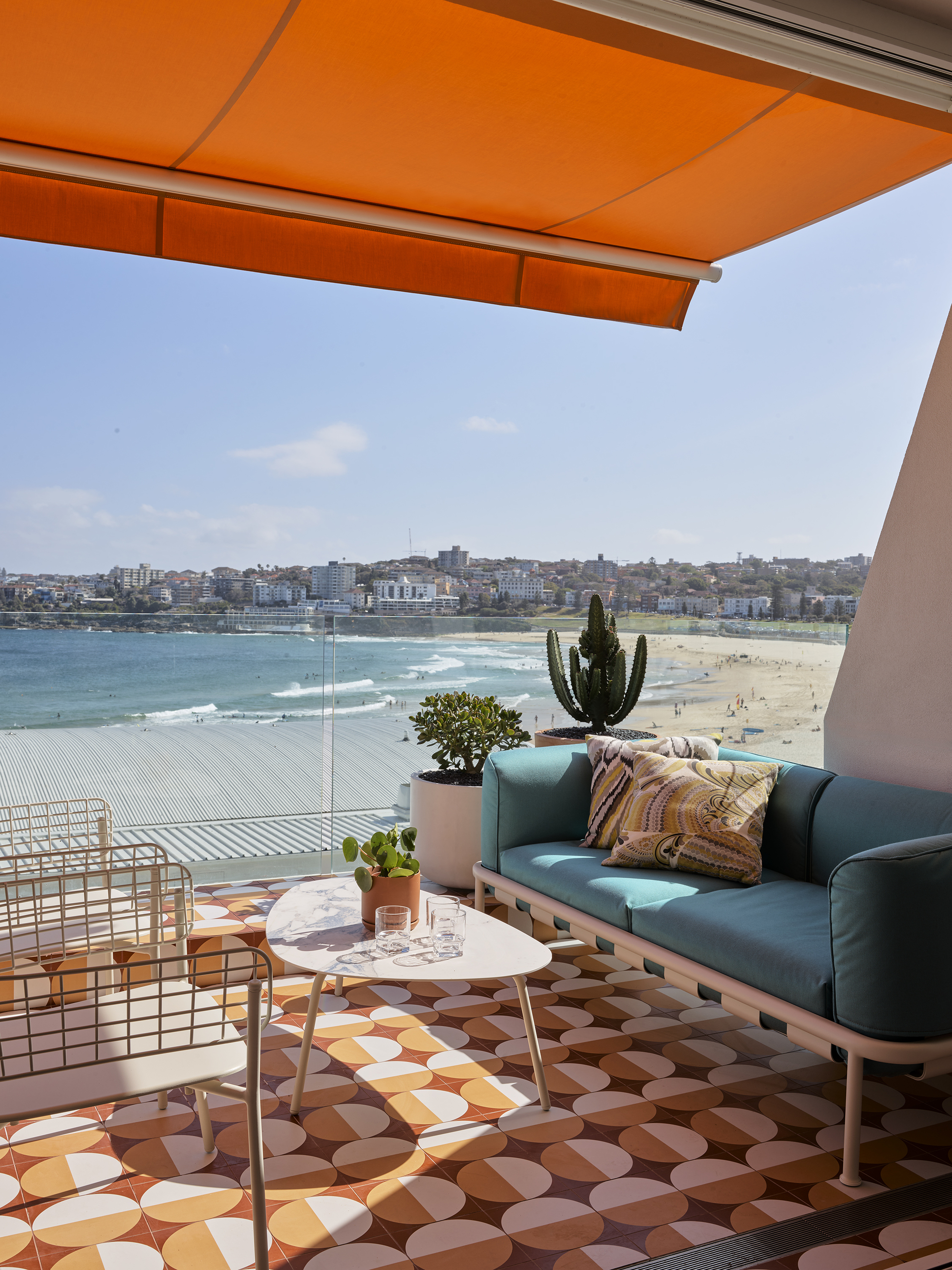 a sunny balcony with an outdoor lounge setting