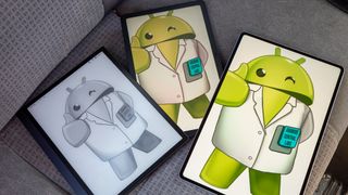 Android Central&#039;s Lloyd mascot dressed up in a lab coat displayed on a TCL Tab 10 NXTPAPER 5G, Onyx Boox Tab Ultra, and an Honor MagicPad 2