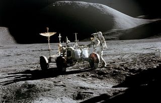 Astronaut James B. Irwin, lunar module pilot, works at the Lunar Roving Vehicle during the first Apollo 15 lunar surface extravehicular activity at the Hadley-Apennine landing site.