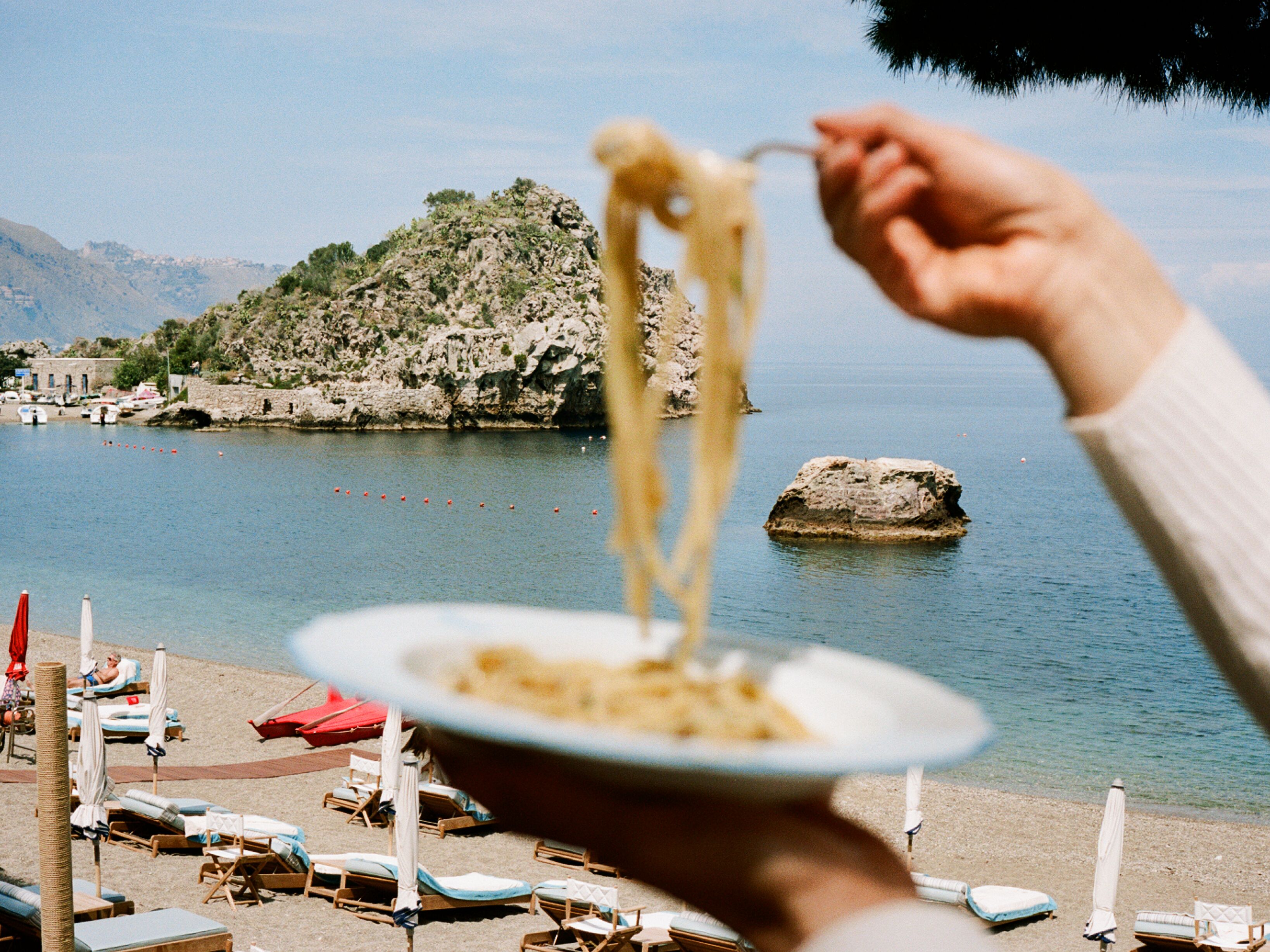 Taormina scene with pasta and coastline