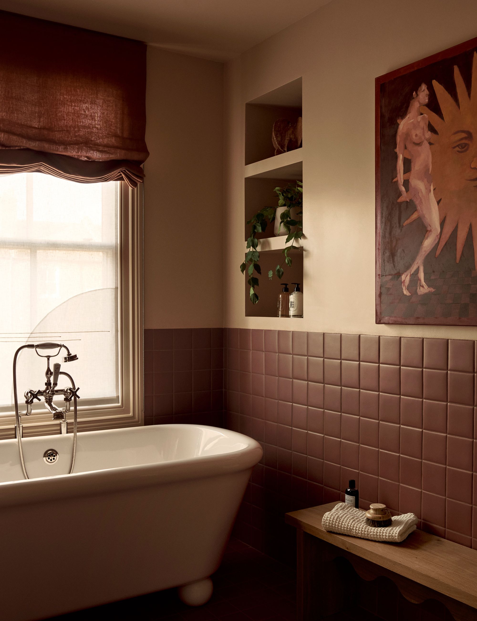 Beige, warm rusty brown and red tones feature in this Pyrland House Bathroom, complete with a free-standing bath tub, brown linen blinds and brown wooden seating