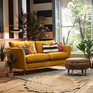 A turmeric colour sofa in a brightly coloured living room