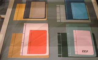 A selection of various sided note books in different colours.