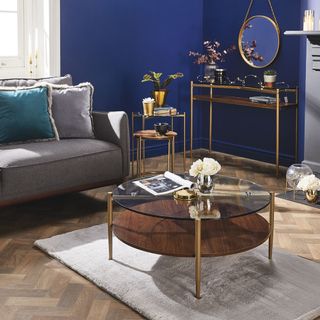 living room with aldis coffee table and dark blue walls
