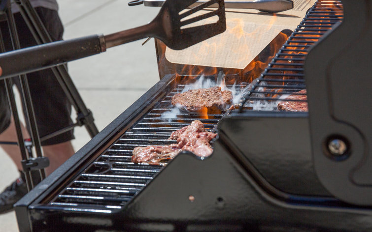 Best gas grills: An image of red meat cooking on a black grill