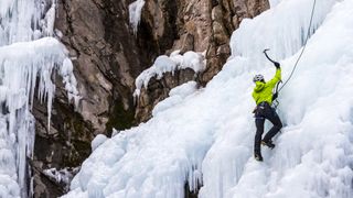 Person ice climbing on waterfall