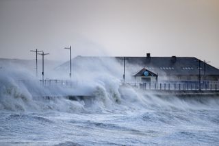 Waves crash against the harbour wall during storm Eunice on February 18, 2022 in Porthcawl, Wales