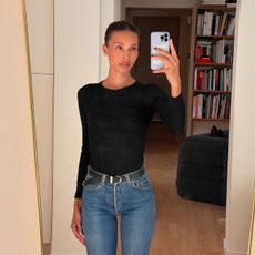 Tylynn Nguyen in a black T-shirt and dark wash jeans.