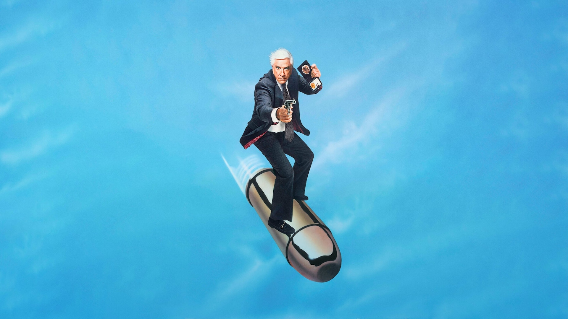 The poster for Naked Gun that shows the lead surfing on a bullet whilst holding up his badge and gun 