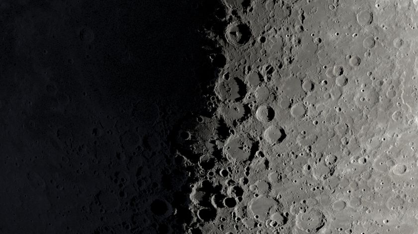A NASA graphic showing a part of the moon's surface around its first quarter phase when its right half is lit by the sun and its left is in shadow. Large craters can be seen lining the night-day divide.