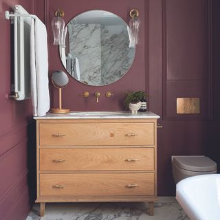 Bathroom with burgundy wall panelling and wooden dresser