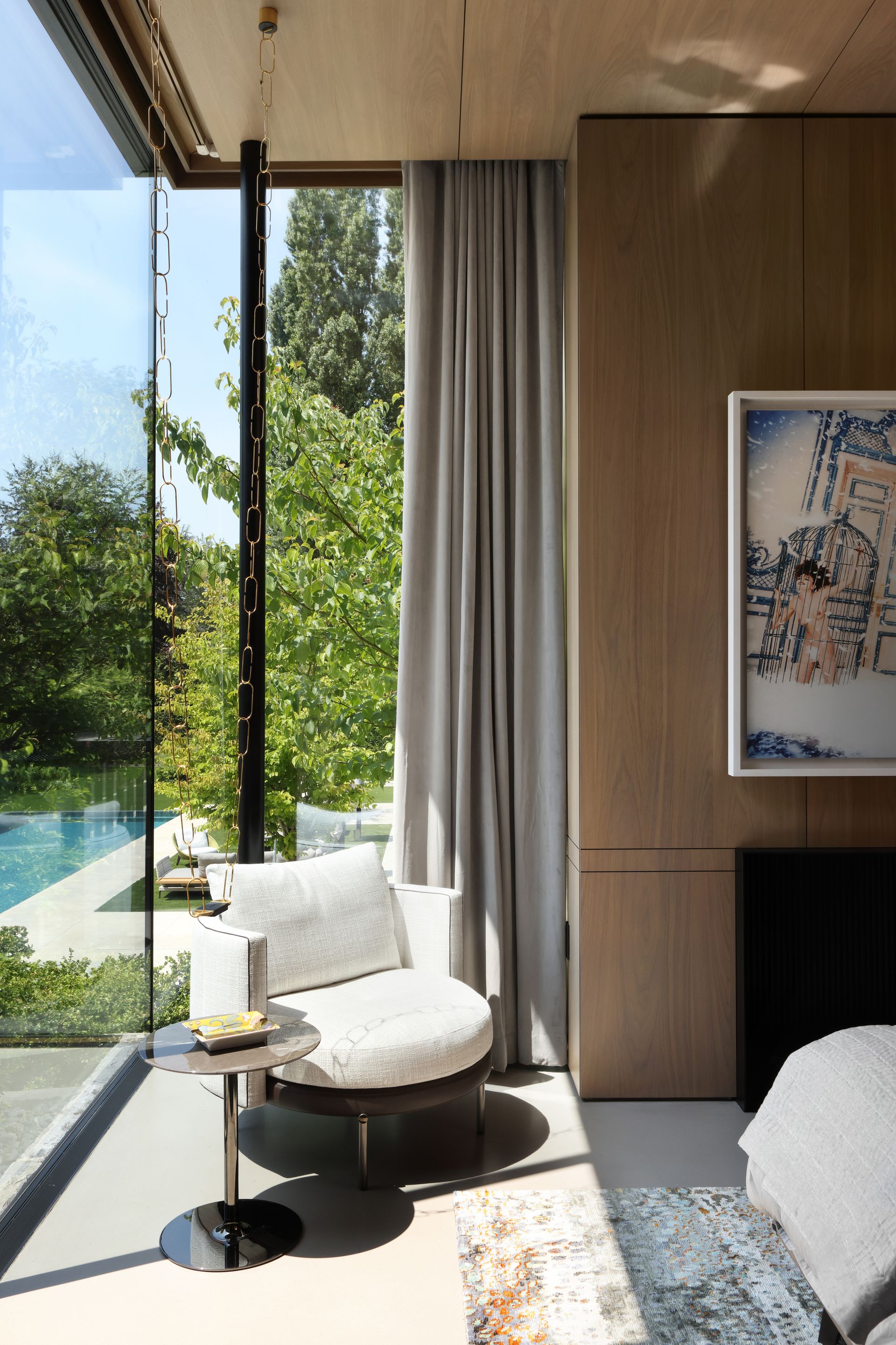 A soft cream chair in a reading corner of the bedroom